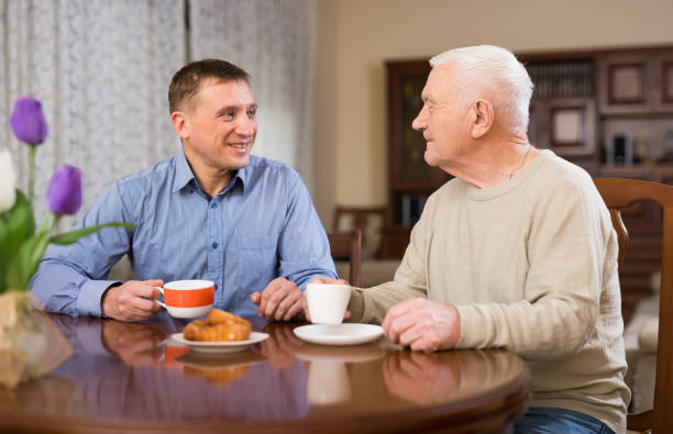 istock Man and his adult son drinking tea 1414094909