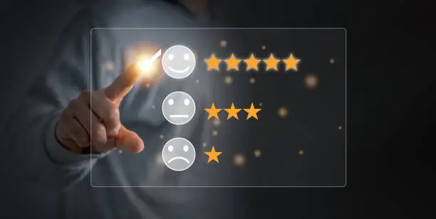 Photo of Customer satisfaction and service quality survey, Businessman pointing a smiley face icon to assess satisfaction with product and services on a virtual screen.