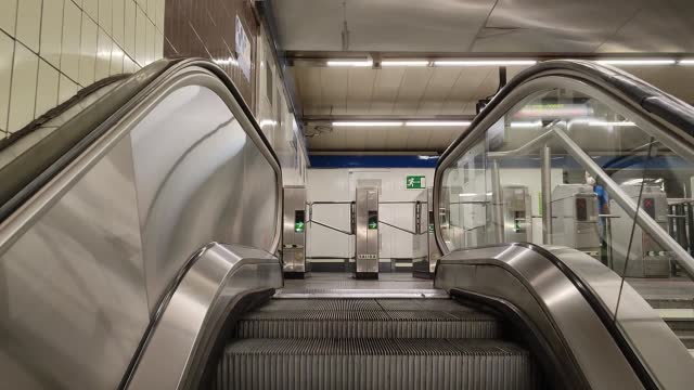 subway escalators going up to exit with an interior industrial metal decoration