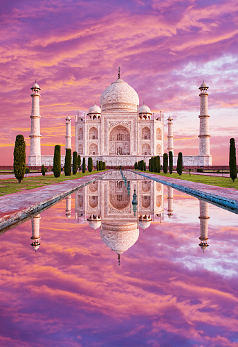 Amazing view on the Taj Mahal in sunset light with reflection in water. The Taj Mahal is an white marble mausoleum on the south bank of the Yamuna river. Agra, Uttar Pradesh, India