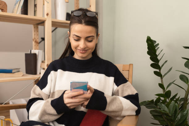 istock Happy woman using mobile phone 1414107153