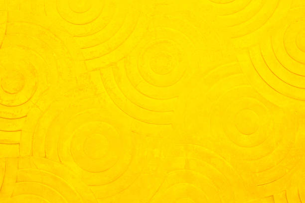 Yellow concrete texture wall background. Abstract orange paint floor stamped concrete surface clean polished on walkway in garden. Wallpaper pattern curved circle rough orange cement stone decorative