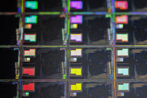 istock Silicon wafer with microchips used in electronics for the fabrication of integrated circuits. Full-frame high-tech macro background. 1414107709