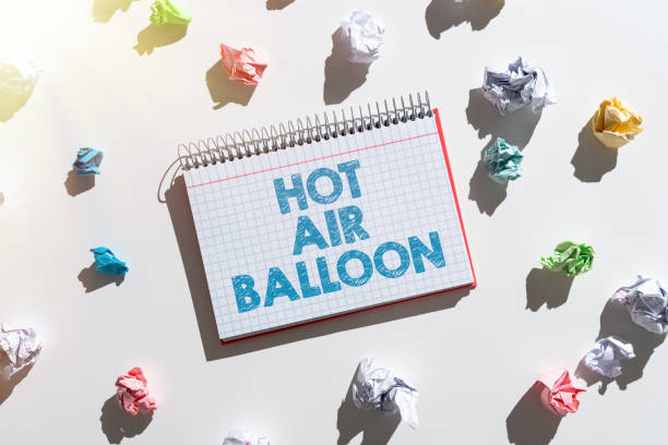 istock Conceptual caption Hot Air Balloon. Concept meaning Have a ride in the inside a basket flight romantic trip Notebook With Important Messages Surrounded By Paper Wraps. 1414107966