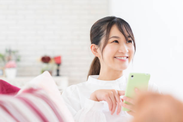 istock attractive Asian woman using a smart phone 1414115898