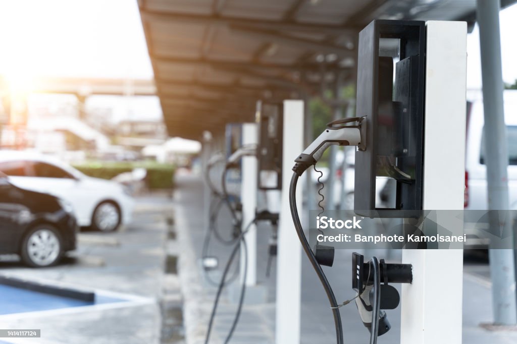 Electric car on electric car charging station. Power supply for electric car charging. Clean energy concept Electric Vehicle Charging Station Stock Photo