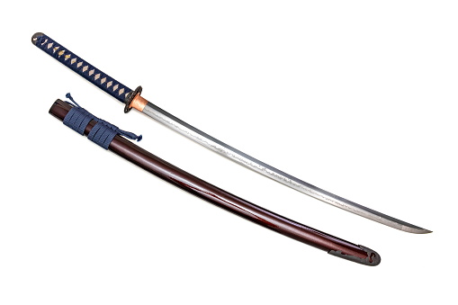 Japanese sword with navy blue cord   steel fitting and shiny crimson red scabbard on white background. Selective focus.