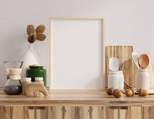 istock Mock up poster frame in kitchen interior with white wall on wood shelf. 1414117326