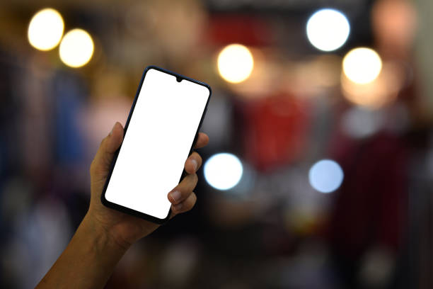 istock Hand holding smartphone with blank screen on bokeh light background 1414118112