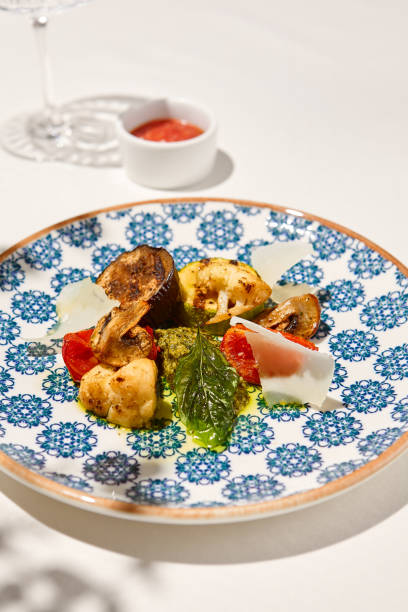 istock Grilled vegetables on light background with shadows. Grilled zucchini, eggplant, paprika, mushrooms. Aesthetic composition with bbq vegetables. Vegan food. Grilled vegetables in Summer menu. 1414120807