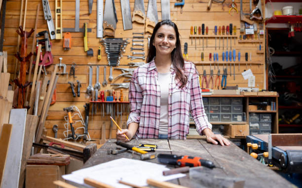 istock Happy woman working on a project in her workshop 1414124788