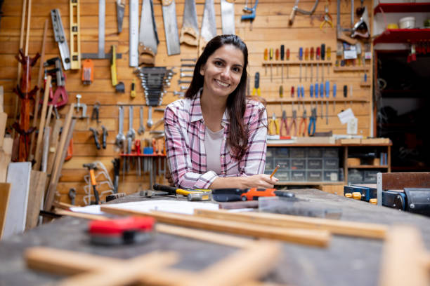 istock Happy woman working on a DIY project in her workshop 1414124797