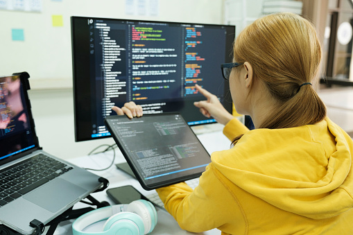 Programmer is coding and programming software. business woman working on computer in the office.