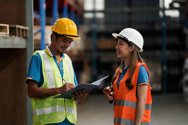 istock Warehouse workers selling stock checks with tablets and bar code launcher,business idea 1414126884