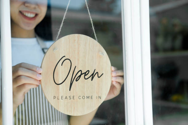 Close up Young asian business owner open the coffee shop. stock photo