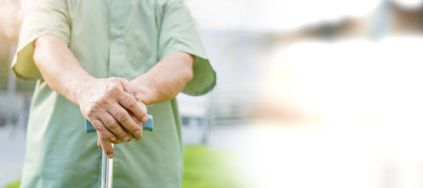 istock Elder man holding a walking cane staff. 1414129767