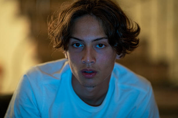 istock Shocked young boy watching a movie during night time 1414130861