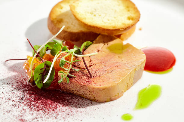 istock Chicken liver pate with toasted bread and jam isolated on white background. Meat terrine with citrus and toast. Restaurant food - duck pate with baguette on white plate. Meat appetizer. 1414134412