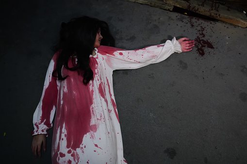 Horror, Scary woman in white dress with bloodstain after murder like ghost in the hallway of haunted house fumble in the dark, Halloween costume party, Horror scene, Nightmare
