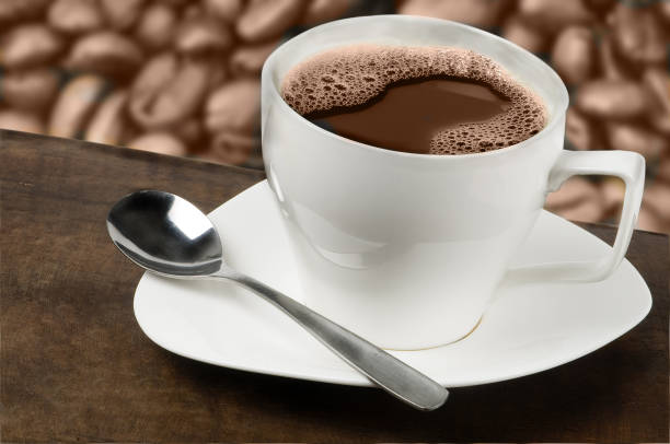 istock White mug with coffee roasted coffee beans in the background 1414143459