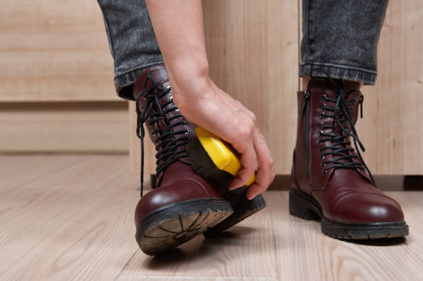 Woman cleaning her own shoes Woman cleaning her own shoes. shoe polish photos stock pictures, royalty-free photos & images