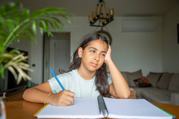 istock A small girl doing homework at a desk at home 1414150820