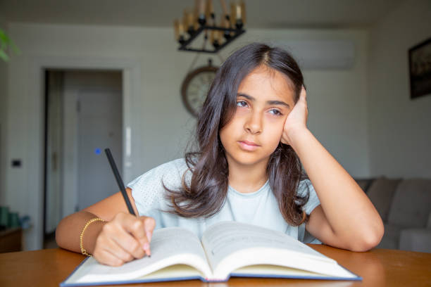 istock Little girl reading a book 1414151004