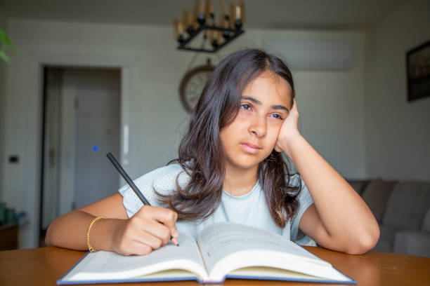 istock Little girl reading a book 1414151006