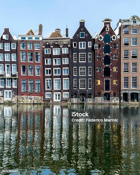 Amsterdams Dancing Houses Reflecting In The River Stock Photo - Download Image Now - Amsterdam, Architecture, Canal