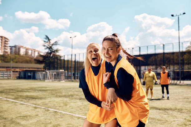 istock Happy athletic women having fun during soccer training  on a stadium. 1414151753