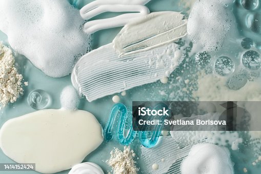 istock Smears of cream, serum, oil, powder. Drops transparent gel serum, cream, powder, oil on a blue background. 1414152424