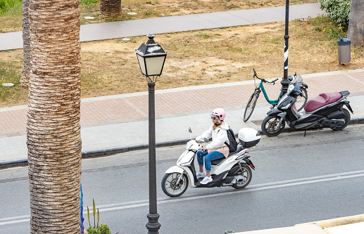 A woman driving a Scooter at Rethymnon Town on Crete, Greece