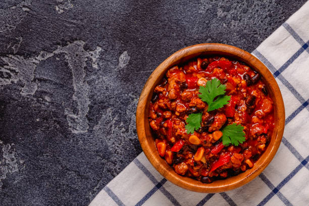 Chili Con Carne in bowl on dark background. stock photo