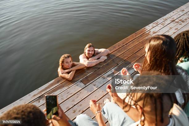 Friends Having Fun By Lake Stock Photo - Download Image Now - Group Of People, Lake, Swimming