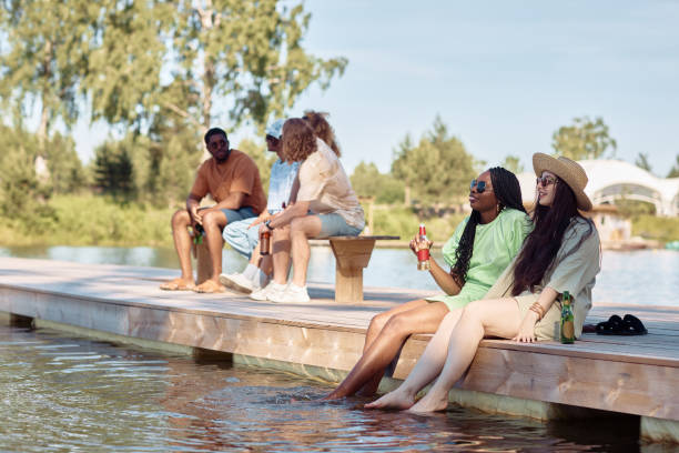 istock Friends Relaxing on Pier by Water 1414155671