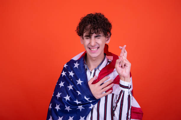 istock Young attractive guy with a flag posing in the studio. 1414159064