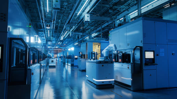 istock Wide Shot Inside Advanced Semiconductor Production Fab Cleanroom. Automated Robots are Transporting Wafers between Machines. 1414159129