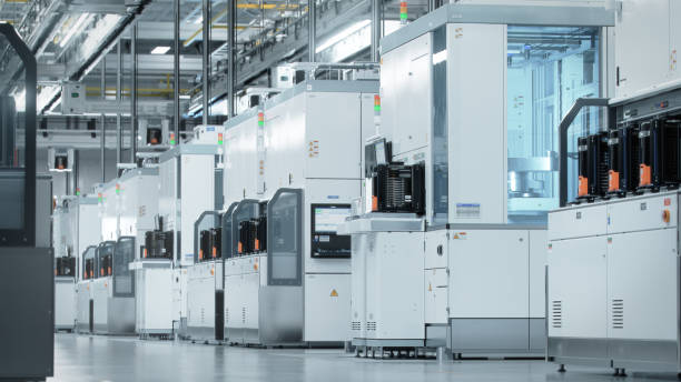 Wide shot of Bright Advanced Semiconductor Production Fab Cleanroom with Working Overhead Wafer Transfer System Wide shot of Bright Advanced Semiconductor Production Fab Cleanroom with Working Overhead Wafer Transfer System computer wafer stock pictures, royalty-free photos & images