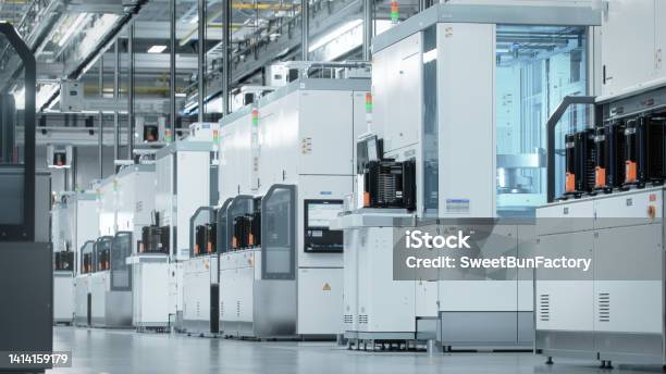 Wide Shot Of Bright Advanced Semiconductor Production Fab Cleanroom With Working Overhead Wafer Transfer System Stock Photo - Download Image Now