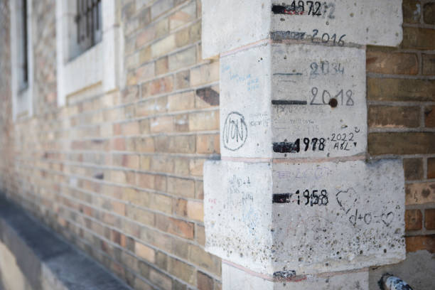 High water marks of the Seine River written by hand on the corner of a building by the river