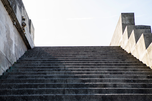 Concrete bright stairs with empty dirty place on the wall, road to success and challenge concept, 3d rendering