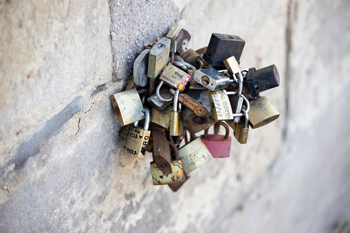 Love locks can be found all over Paris - seen here on a stone wall near Pont Saint-Michel