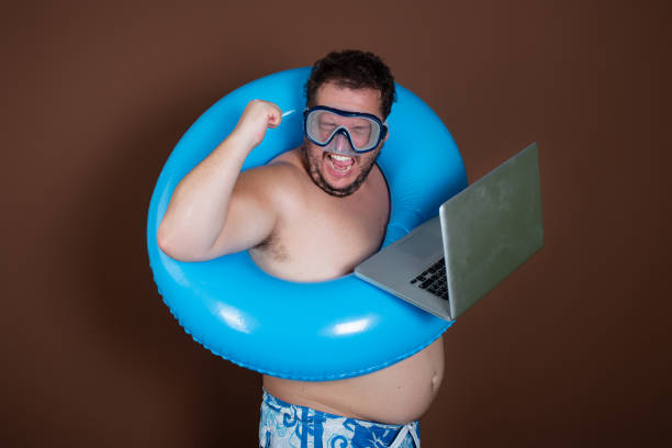 istock Vacation and holidays. Funny fat man is going to the sea. 1414166360