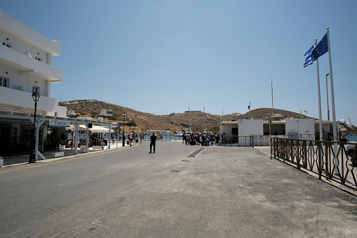 Ios, Greece - June 9, 2021 : Tourists waiting for the ferry boat at the port of Ios Greece