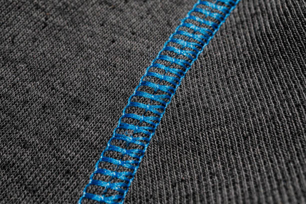 Close up of an blue seam on a grey sport shirt