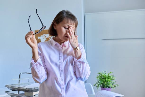 istock Mature tired woman experiencing stress headache depression 1414169753
