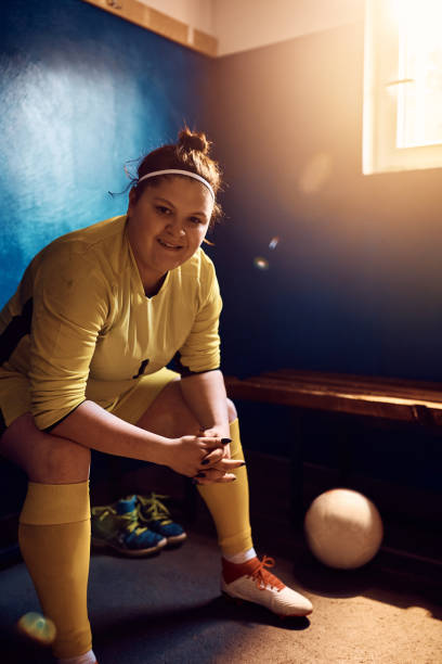 istock Happy female goalkeeper in locker room looking at camera. 1414170024