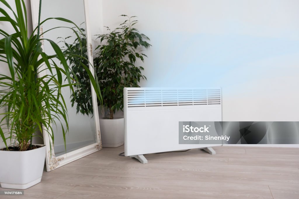 Modern electric infrared heater in living room Modern electric infrared heater in living room. Electric Heater Stock Photo