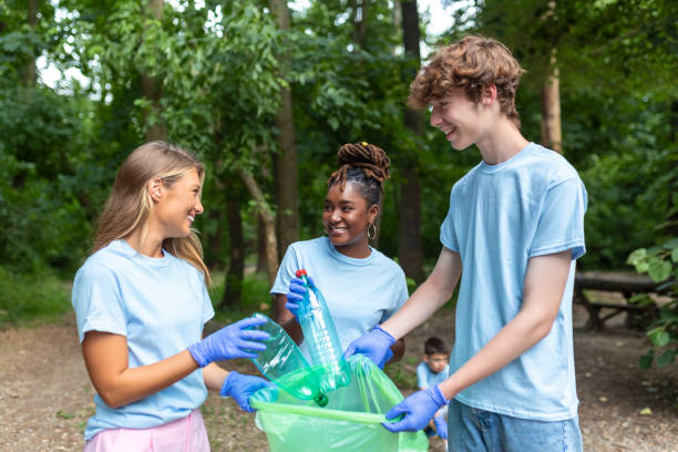 istock A successful day for three young beautiful volunteers. Those standing are holding a garbage bag with a toothy smile. 1414171701