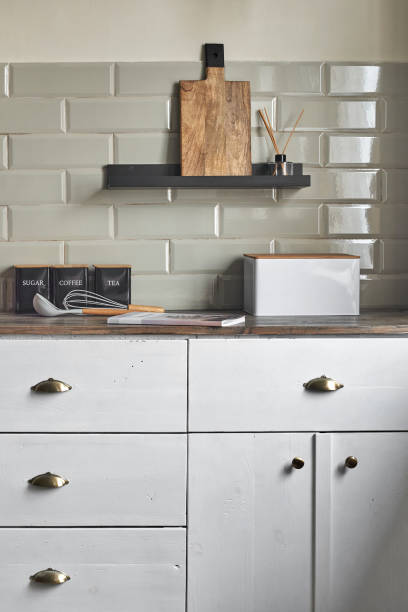 istock Kitchen white cabinets with kitchen utensils on the counter. 1414173508